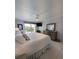 Bright primary bedroom with balcony access, neutral tones, and ample dresser space at 150 Belleview Blvd # 307, Belleair, FL 33756