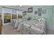 Bright bedroom with sliding glass doors to a balcony and two queen beds at 150 Belleview Blvd # 307, Belleair, FL 33756