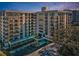 Multi-story condo building with balconies and well-maintained landscaping at 150 Belleview Blvd # 307, Belleair, FL 33756