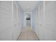 Bright hallway featuring white closet doors providing ample storage, and tile flooring at 150 Belleview Blvd # 307, Belleair, FL 33756