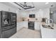 Modern kitchen featuring white cabinets, stainless steel appliances, and stylish countertops at 150 Belleview Blvd # 307, Belleair, FL 33756