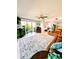 Spacious living room with comfortable seating, a ceiling fan, and large windows with an outdoor view at 150 Belleview Blvd # 307, Belleair, FL 33756