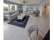 Spacious living room featuring tile flooring, two sofas, and an area rug at 150 Belleview Blvd # 307, Belleair, FL 33756