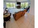 Cozy living room featuring tile floors, recliner and sliding glass door access to balcony at 150 Belleview Blvd # 307, Belleair, FL 33756