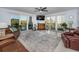 Spacious living room with floor to ceiling sliding doors, tiled floor, comfortable leather seating, and a wet bar at 150 Belleview Blvd # 307, Belleair, FL 33756