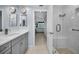 Modern main bathroom featuring a glass-enclosed shower, a stylish vanity with double sinks, and a tiled floor at 150 Belleview Blvd # 307, Belleair, FL 33756