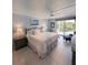 Serene main bedroom with a comfortable bed, soft lighting, and access to a balcony at 150 Belleview Blvd # 307, Belleair, FL 33756