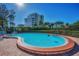 Community pool with brick surround and view of building in the background at 150 Belleview Blvd # 307, Belleair, FL 33756