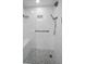 Stylish shower with gray stone floor, bench seat, and rainfall shower head at 150 Belleview Blvd # 307, Belleair, FL 33756