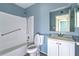 Cozy blue bathroom featuring a shower-tub combo, a toilet, and a vanity at 1517 Danbury Dr, Sun City Center, FL 33573