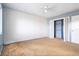 Bright bedroom with two-toned walls, carpeted floors, a ceiling fan, and a large closet at 1517 Danbury Dr, Sun City Center, FL 33573