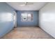 Cozy bedroom features two-toned walls, carpeted floors, a ceiling fan, and a street view through a large window at 1517 Danbury Dr, Sun City Center, FL 33573