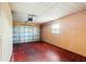 An attached garage with a standard white door and a red painted floor at 1517 Danbury Dr, Sun City Center, FL 33573