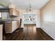 Open-concept kitchen and dining area with dark wood-look floors and vintage-style lighting at 1517 Danbury Dr, Sun City Center, FL 33573