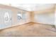 Comfortable living room features neutral walls, carpeted floors, a white ceiling fan, and natural light at 1517 Danbury Dr, Sun City Center, FL 33573