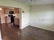 An open living space looking into the kitchen featuring hardwood flooring at 1517 Danbury Dr, Sun City Center, FL 33573