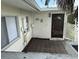 A fenced patio area featuring pavers, a palm tree, and a view of the back door and back of the home at 1517 Danbury Dr, Sun City Center, FL 33573