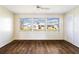 A bright sunroom with wood-look floors, large windows, and lots of natural light at 1517 Danbury Dr, Sun City Center, FL 33573