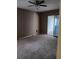 Bedroom showcasing neutral carpet, sliding glass doors, a ceiling fan and ample space at 1606 Comfy Ct, Sun City Center, FL 33573