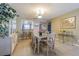 Dining room with wicker chairs, glass table and a breakfast bar view to the kitchen at 1750 Belleair Forest Dr # A7, Belleair, FL 33756