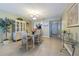 Dining room with wicker chairs, a glass table and a view to the kitchen through a breakfast bar at 1750 Belleair Forest Dr # A7, Belleair, FL 33756