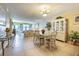 Spacious living and dining area with tile floors, comfortable seating, and ample natural light at 1750 Belleair Forest Dr # A7, Belleair, FL 33756