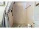 A stall shower in the bathroom with neutral-colored tile and a black mosaic tile floor at 1750 Belleair Forest Dr # A7, Belleair, FL 33756