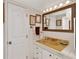 Small bathroom with a yellow sink, wall art, and framed mirror at 18675 Us Highway 19 N # 251, Clearwater, FL 33764