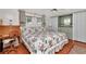Cozy bedroom with floral bedding, natural light, and wood floors at 18675 Us Highway 19 N # 251, Clearwater, FL 33764