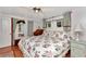 Cozy bedroom with a floral-patterned bedspread, vintage furniture, and ceiling fan at 18675 Us Highway 19 N # 251, Clearwater, FL 33764