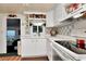 Bright kitchen featuring white cabinetry, modern appliances, and neutral countertops at 18675 Us Highway 19 N # 251, Clearwater, FL 33764