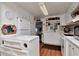Well-lit kitchen with white cabinets and a black and white backsplash at 18675 Us Highway 19 N # 251, Clearwater, FL 33764