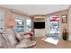Comfortable living area featuring a television, patio access, and ample natural light at 18675 Us Highway 19 N # 251, Clearwater, FL 33764