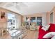 Bright living room with a ceiling fan, sliding doors to the patio, and comfortable seating at 18675 Us Highway 19 N # 251, Clearwater, FL 33764