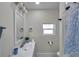 Bright bathroom featuring a white vanity with a mirror and decorative accents, and a window at 2011 1St St, Indian Rocks Beach, FL 33785