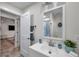 Bright bathroom with a white vanity, a mirror, and a glimpse into an adjacent room at 2011 1St St, Indian Rocks Beach, FL 33785