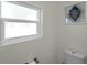 Clean bathroom with a frosted window and a seashell decoration, alongside standard fixtures at 2011 1St St, Indian Rocks Beach, FL 33785