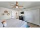 Comfortable bedroom featuring a ceiling fan, closet, and a dresser with wall-mounted TV at 2011 1St St, Indian Rocks Beach, FL 33785
