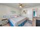 Relaxing bedroom with ceiling fan, beach-themed art, and stylish furnishings at 2011 1St St, Indian Rocks Beach, FL 33785