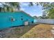 Turquoise home exterior with tropical landscaping and a well-maintained lawn at 2011 1St St, Indian Rocks Beach, FL 33785