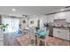 Open kitchen and dining area with white cabinetry and modern appliances at 2011 1St St, Indian Rocks Beach, FL 33785