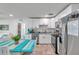 Updated kitchen featuring white cabinetry, stainless steel appliances, granite countertops, and a view of the dining area at 2011 1St St, Indian Rocks Beach, FL 33785