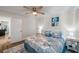 Inviting bedroom with a ceiling fan, side tables, and beach-themed bedding for ultimate comfort at 2011 1St St, Indian Rocks Beach, FL 33785