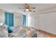 Comfortable bedroom with a ceiling fan, closet, and coastal-inspired bedding for a relaxing ambiance at 2011 1St St, Indian Rocks Beach, FL 33785