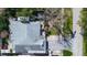 Overhead view of a home with a gray roof, green lawn, and mature trees at 2100 Mcmullen Rd, Largo, FL 33771