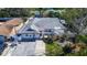 Aerial view of a charming home with a white exterior, red door, and well-manicured landscaping at 2100 Mcmullen Rd, Largo, FL 33771