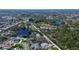 Aerial view showcasing a residential area with lush greenery, lakes and well-maintained properties at 2100 Mcmullen Rd, Largo, FL 33771