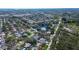 Aerial view of a charming neighborhood with mature trees, multiple ponds, and well-spaced homes at 2100 Mcmullen Rd, Largo, FL 33771