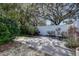 Backyard featuring a stone patio, white fencing, and lush landscaping at 2100 Mcmullen Rd, Largo, FL 33771