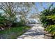 A shady backyard featuring a stone patio and white fencing at 2100 Mcmullen Rd, Largo, FL 33771